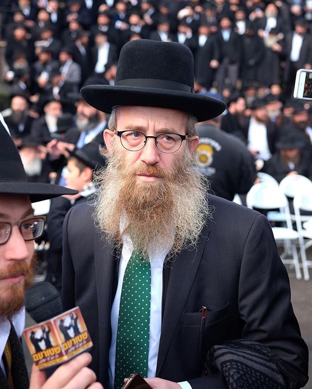 Chabad Chassidim typically wear a fedora so the few that don't really stand out. It's interesting when chassidim borrow from each other's style. I'm sure it's for a good reason. (Perhaps he grew up in a non-chabad family)