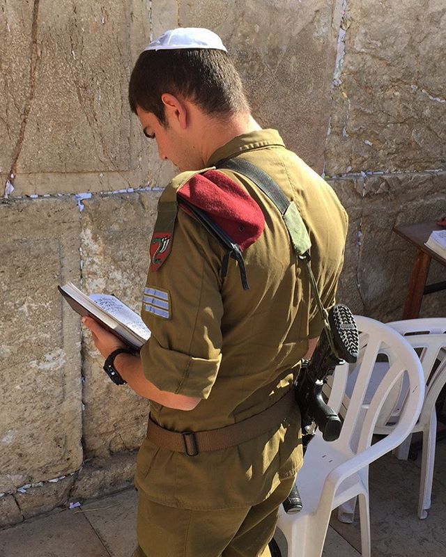 A soldier prays at the Western Wall