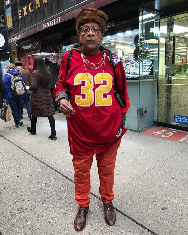 I’ve seen a hoodie under a football jersey, i’ve never seen a jersey worn with hard bottoms. This dude is a real champ.